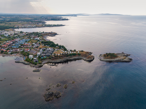 Aerial view of Arapya coastline featuring a small rocky island coastal buildings and calm waters of the Black Sea in Burgas Bulgaria. Aerial view of Arapya coastline featuring a small rocky island coastal buildings and calm waters of the Black Sea in Burgas Bulgaria.