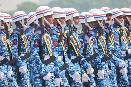 Dhaka Bangladesh 25 March 2026 View of uniformed personnel a sea of blue camouflage and white helmets marching in precise formation.