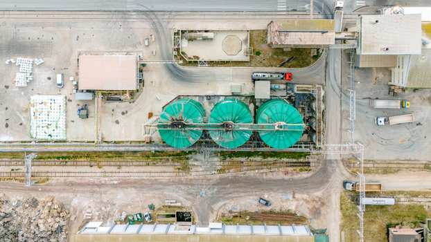 Aerial view of three large green silos at an industrial facility with trucks and railway tracks in Sabac Serbia. Aerial view of three large green silos at an industrial facility with trucks and railway tracks in Sabac Serbia.