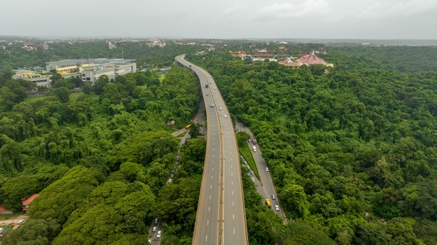 Aerial view of the Atal Setu bridge surrounded by dense tropical forest and lush greenery in Panaji Goa India.