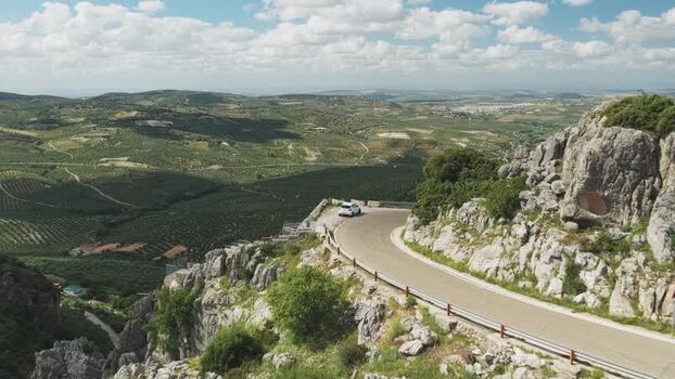 Aerial view of a winding mountain road and rocky cliffs Spain.
