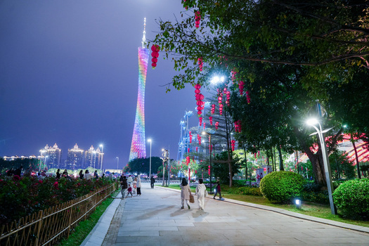 Guangzhou China 24 February 2024 View of the illuminated Canton Tower rising above a pedestrian walkway decorated with red lanterns in the evening. Guangzhou China 24 February 2024 View of the illuminated Canton Tower rising above a pedestrian walkway decorated with red lanterns in the evening.