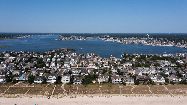 Aerial view of residential houses along the sandy beach and bay in Mantoloking New Jersey United States. Aerial view of residential houses along the sandy beach and bay in Mantoloking New Jersey United States.