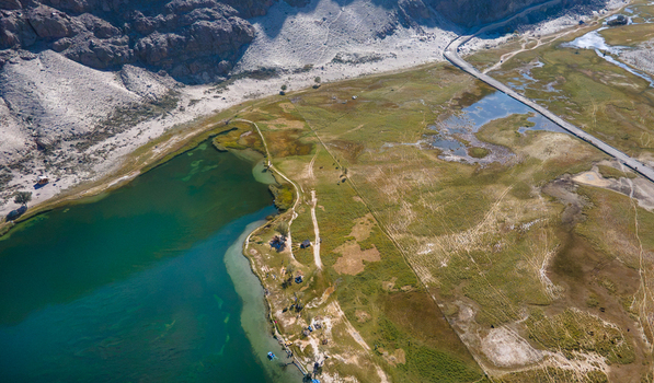 Aerial view of Blind Lake Sarfaranga Shigar with its turquoise waters surrounded by arid sandy banks and rugged mountain terrain in Skardu Gilgit Pakistan.
