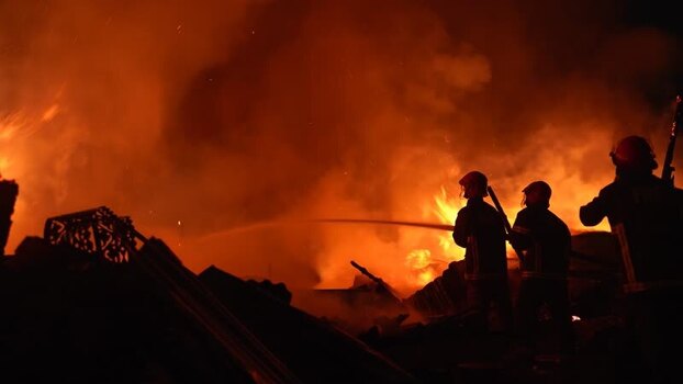 View of firefighters battling a massive fire at night Bangladesh. View of firefighters battling a massive fire at night Bangladesh.
