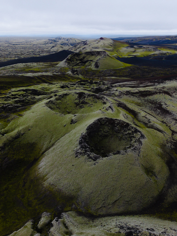 Aerial view of mossy green volcanic craters punctuate the stark landscape under a cloudy sky Lakagigar Iceland. Aerial view of mossy green volcanic craters punctuate the stark landscape under a cloudy sky Lakagigar Iceland.