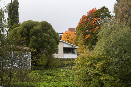 View of a house nestled among vibrant autumn trees with orange and yellow foliage in a residential area of Jyvaskyla Central Finland Finland.