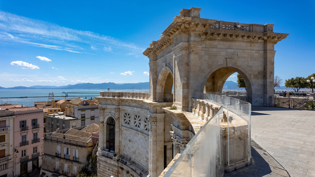 View of the Bastione di Saint Remy featuring its neoclassical stone arch and terrace overlooking city rooftops and the Mediterranean Sea in Cagliari Sardegna Italy. View of the Bastione di Saint Remy featuring its neoclassical stone arch and terrace overlooking city rooftops and the Mediterranean Sea in Cagliari Sardegna Italy.