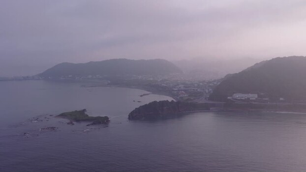 Aerial view of misty coastal landscape in Japan.