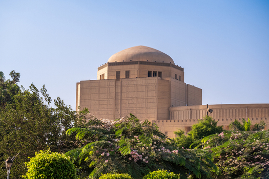 View of Cairo Opera House with a dome rises majestically above lush greenery under a clear sky Zamalek Cairo Governorate Egypt. View of Cairo Opera House with a dome rises majestically above lush greenery under a clear sky Zamalek Cairo Governorate Egypt.