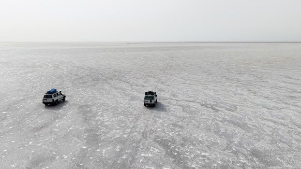 Aerial view of off road vehicles on the Danakil Desert salt flats Ethiopia. Aerial view of off road vehicles on the Danakil Desert salt flats Ethiopia.