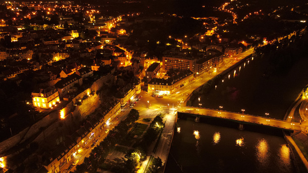 Aerial view of the historic town at night featuring illuminated streets buildings and a bridge over the Oise River in Pontoise Ile de France France. Aerial view of the historic town at night featuring illuminated streets buildings and a bridge over the Oise River in Pontoise Ile de France France.