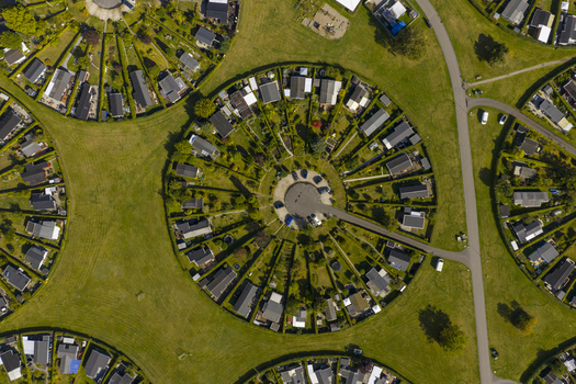 Aerial view of the unique circular garden community of Brondby Haveby with lush green hedges and small houses under bright sunlight in Brondby Denmark. Aerial view of the unique circular garden community of Brondby Haveby with lush green hedges and small houses under bright sunlight in Brondby Denmark.