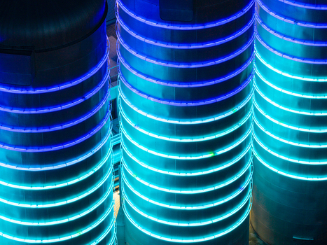 Aerial view of the BTB Heat and Power Plant Adlershof featuring glowing blue and cyan LED rings on industrial heat storage tanks visualizing real time energy data in Berlin Berlin Germany. Aerial view of the BTB Heat and Power Plant Adlershof featuring glowing blue and cyan LED rings on industrial heat storage tanks visualizing real time energy data in Berlin Berlin Germany.