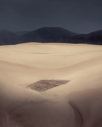 View of the vast sand dunes of Daira with dark mountains under a dramatic stormy sky Da ira Socotra Yemen.