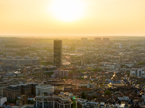 Aerial view of the Brussels skyline at sunset featuring the Finance Tower rising above the dense urban landscape with warm golden light in Brussels Brussels Belgium. Aerial view of the Brussels skyline at sunset featuring the Finance Tower rising above the dense urban landscape with warm golden light in Brussels Brussels Belgium.