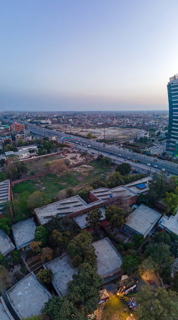 Aerial view of the Arfa Kareem Tower and busy highway traffic surrounded by urban buildings and green trees in Lahore Punjab Pakistan. Aerial view of the Arfa Kareem Tower and busy highway traffic surrounded by urban buildings and green trees in Lahore Punjab Pakistan.
