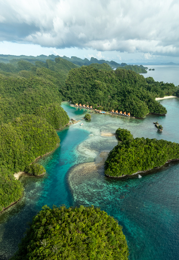 Aerial view of Bucas Grande featuring lush green islands surrounded by turquoise waters coral reefs and small resort structures in Siargao Philippines. Aerial view of Bucas Grande featuring lush green islands surrounded by turquoise waters coral reefs and small resort structures in Siargao Philippines.