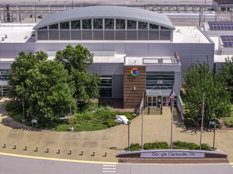 Clarksville Tennessee United States 04 July 2026 Aerial view of the Google Data Center featuring the modern facility entrance landscaped greenery and the American flag.