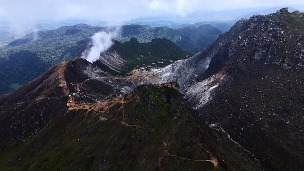 Aerial view of Mount Sibayak volcano with steam rising Indonesia. Aerial view of Mount Sibayak volcano with steam rising Indonesia.