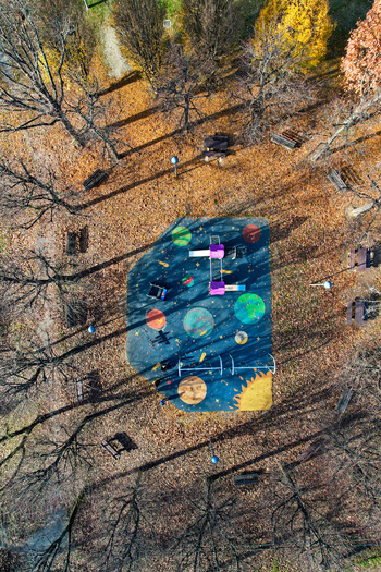 Aerial view of a space themed playground surrounded by autumn trees and fallen leaves in Turin Piedmont Italy. Aerial view of a space themed playground surrounded by autumn trees and fallen leaves in Turin Piedmont Italy.