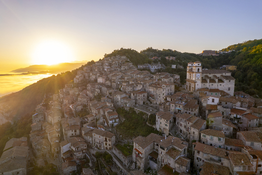 Aerial view of the historic town of Artena with its stone houses and church perched on a hillside at sunset in Artena Lazio Italy.