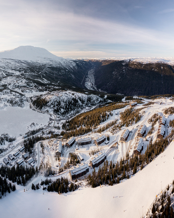 Aerial view of Gaustablikk Fjellresort surrounded by snow covered slopes pine forests and frozen lakes in Rjukan Telemark Norway. Aerial view of Gaustablikk Fjellresort surrounded by snow covered slopes pine forests and frozen lakes in Rjukan Telemark Norway.