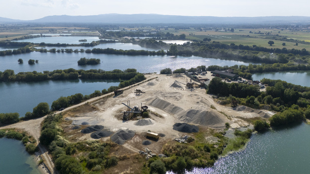 Aerial view of Extraccion de aridos Lima S.L gravel extraction site with piles of sand and gravel machinery and surrounding water reservoirs in Vilarino das Poldras Ourense Spain. Aerial view of Extraccion de aridos Lima S.L gravel extraction site with piles of sand and gravel machinery and surrounding water reservoirs in Vilarino das Poldras Ourense Spain.