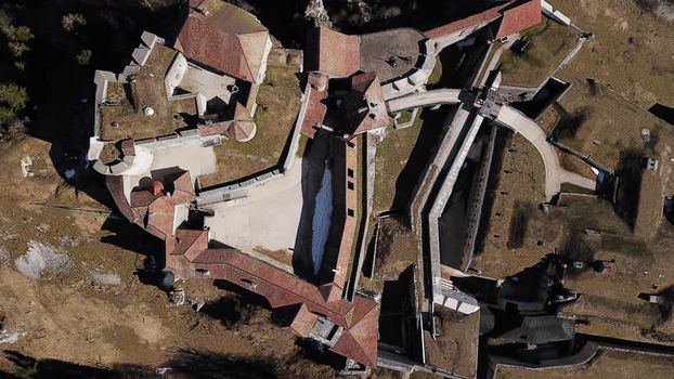 Aerial view of Chateau de Joux showing the historic fortress with its stone walls red tiled roofs and courtyards in La Cluse et Mijoux Bourgogne Franche Comte France. Aerial view of Chateau de Joux showing the historic fortress with its stone walls red tiled roofs and courtyards in La Cluse et Mijoux Bourgogne Franche Comte France.
