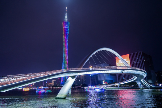 Guangzhou China 24 February 2024 View of the illuminated Canton Tower and Haixin Bridge spanning the Pearl River at night with vibrant city lights reflecting on the water. Guangzhou China 24 February 2024 View of the illuminated Canton Tower and Haixin Bridge spanning the Pearl River at night with vibrant city lights reflecting on the water.