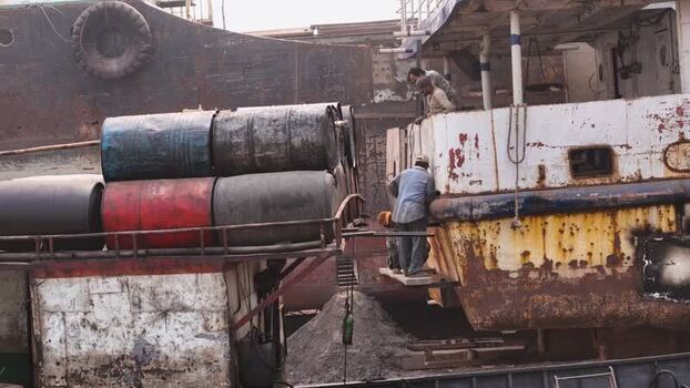 Aerial view of workers on a rusty ship in Dhaka Bangladesh. Aerial view of workers on a rusty ship in Dhaka Bangladesh.
