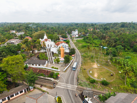 Aerial view of the Kumarakanda Kumara Maha Viharaya Royal Prince Temple of Kumarakanda with its white stupa and golden Buddha statue in Hikkaduwa Southern Province Sri Lanka. Aerial view of the Kumarakanda Kumara Maha Viharaya Royal Prince Temple of Kumarakanda with its white stupa and golden Buddha statue in Hikkaduwa Southern Province Sri Lanka.