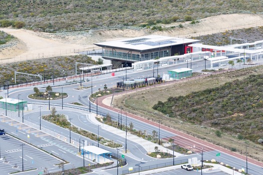 Aerial view of a modern train station with a bus interchange parking facilities and surrounding native vegetation in Perth Western Australia Australia. Aerial view of a modern train station with a bus interchange parking facilities and surrounding native vegetation in Perth Western Australia Australia.
