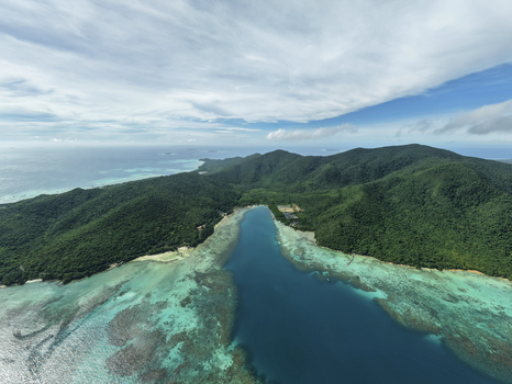 Aerial view of the lush green island meeting the turquoise sea in a stunning display of nature s artistry Karimunjawa Central Java Indonesia.