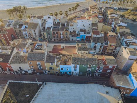 Aerial view of the iconic colorful houses and sandy beach with palm trees in La Vila Joiosa Valencian Community Spain. Aerial view of the iconic colorful houses and sandy beach with palm trees in La Vila Joiosa Valencian Community Spain.
