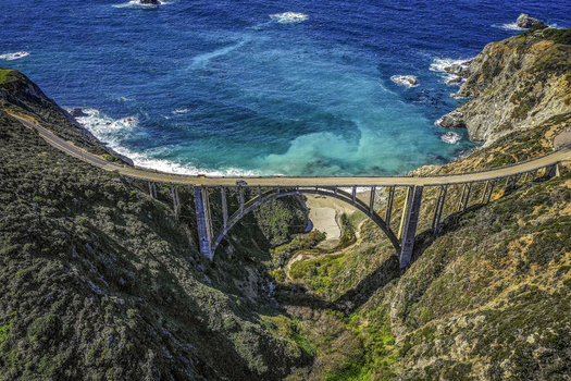 Aerial view of Bixby Creek Bridge over the rocky cliffside and turquoise ocean Big Sur California United States.