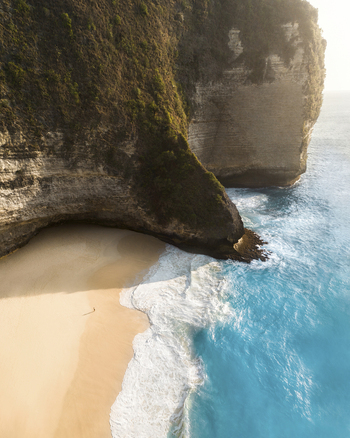 Aerial view of a person on the beach at Kelingking Beach Nusa Penida Indonesia.