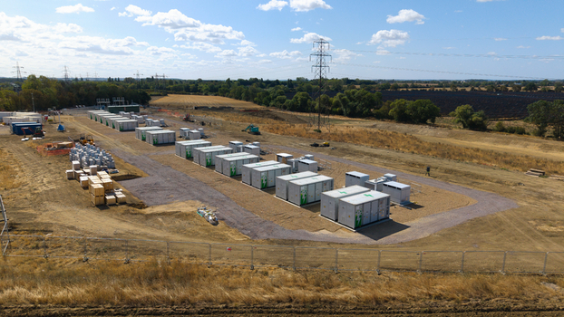 Aerial view of the Eaton Socon battery energy storage system facility with rows of white storage containers and electrical infrastructure in St. Neots England United Kingdom. Aerial view of the Eaton Socon battery energy storage system facility with rows of white storage containers and electrical infrastructure in St. Neots England United Kingdom.
