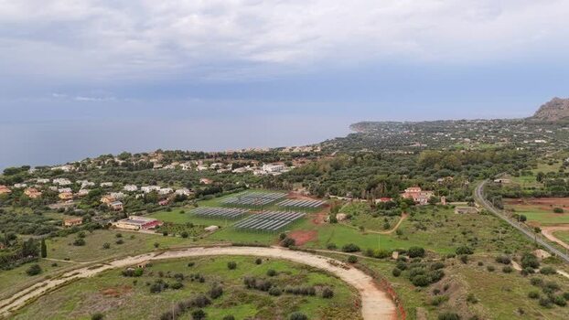 Aerial view of solar panels in the landscape of Italy.
