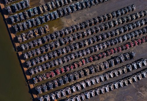 Aerial view of rows of scrapped heavy duty truck engines arranged in a salvage yard near a riverbank in Kalamazoo Michigan United States. Aerial view of rows of scrapped heavy duty truck engines arranged in a salvage yard near a riverbank in Kalamazoo Michigan United States.