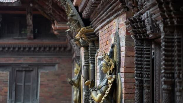 View of golden statues and wood carvings in Kathmandu Nepal.