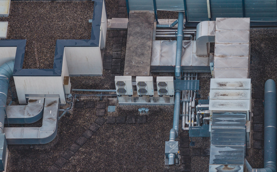 Aerial view of rooftop HVAC infrastructure featuring industrial ventilation ducts air handling units and mechanical systems on a commercial building in Valence Auvergne Rhone Alpes France.
