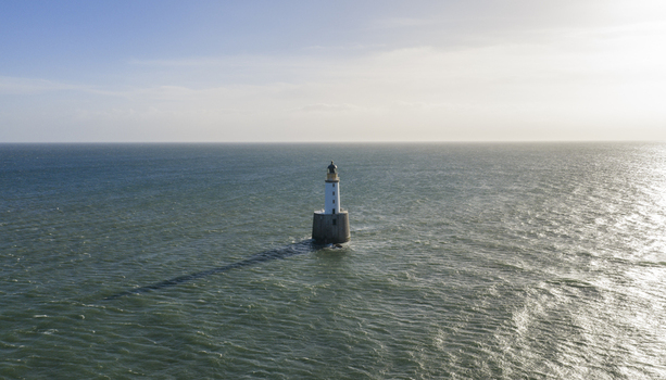 Aerial view of Rattray Head Lighthouse standing in the North Sea with gentle waves and a clear horizon Peterhead Scotland United Kingdom. Aerial view of Rattray Head Lighthouse standing in the North Sea with gentle waves and a clear horizon Peterhead Scotland United Kingdom.