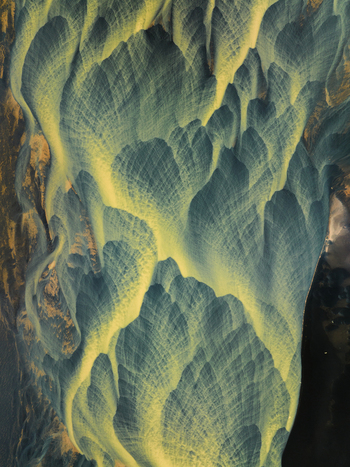 Aerial view of intricate patterns and textures where icy blue rivers meet the golden sands of the Icelandic landscape Iceland Iceland. Aerial view of intricate patterns and textures where icy blue rivers meet the golden sands of the Icelandic landscape Iceland Iceland.