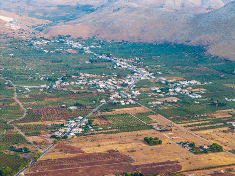 Aerial view of a small town nestled in the rural landscape of Sicily surrounded by olive groves agricultural fields and rolling hills Palermo Sicily Italy. Aerial view of a small town nestled in the rural landscape of Sicily surrounded by olive groves agricultural fields and rolling hills Palermo Sicily Italy.