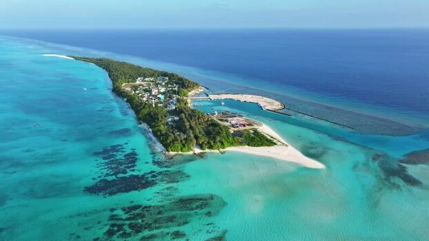 Aerial view of Fulhadhoo island with turquoise lagoons and lush palms Maldives. Aerial view of Fulhadhoo island with turquoise lagoons and lush palms Maldives.
