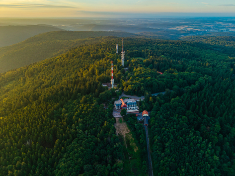 Aerial view of the Konigstuhl summit featuring communication towers and dense forest at sunset in Heidelberg Baden Wurttemberg Germany.