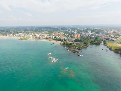 Aerial view of the turquoise coastline and urban skyline with rocky outcrops and sandy beaches in Galle Southern Province Sri Lanka. Aerial view of the turquoise coastline and urban skyline with rocky outcrops and sandy beaches in Galle Southern Province Sri Lanka.