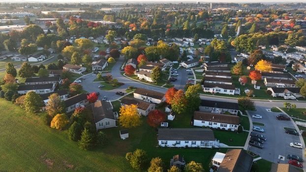 Aerial view of a suburban residential neighborhood with colorful autumn foliage paved streets and parked cars in East Lampeter Township Pennsylvania United States. Aerial view of a suburban residential neighborhood with colorful autumn foliage paved streets and parked cars in East Lampeter Township Pennsylvania United States.