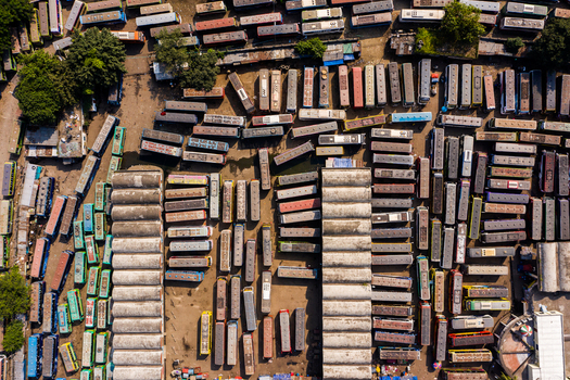 Aerial view of the Gabtoli Bus Terminal Internal Road featuring rows of parked buses and concrete terminal structures in Dhaka Dhaka Division Bangladesh.